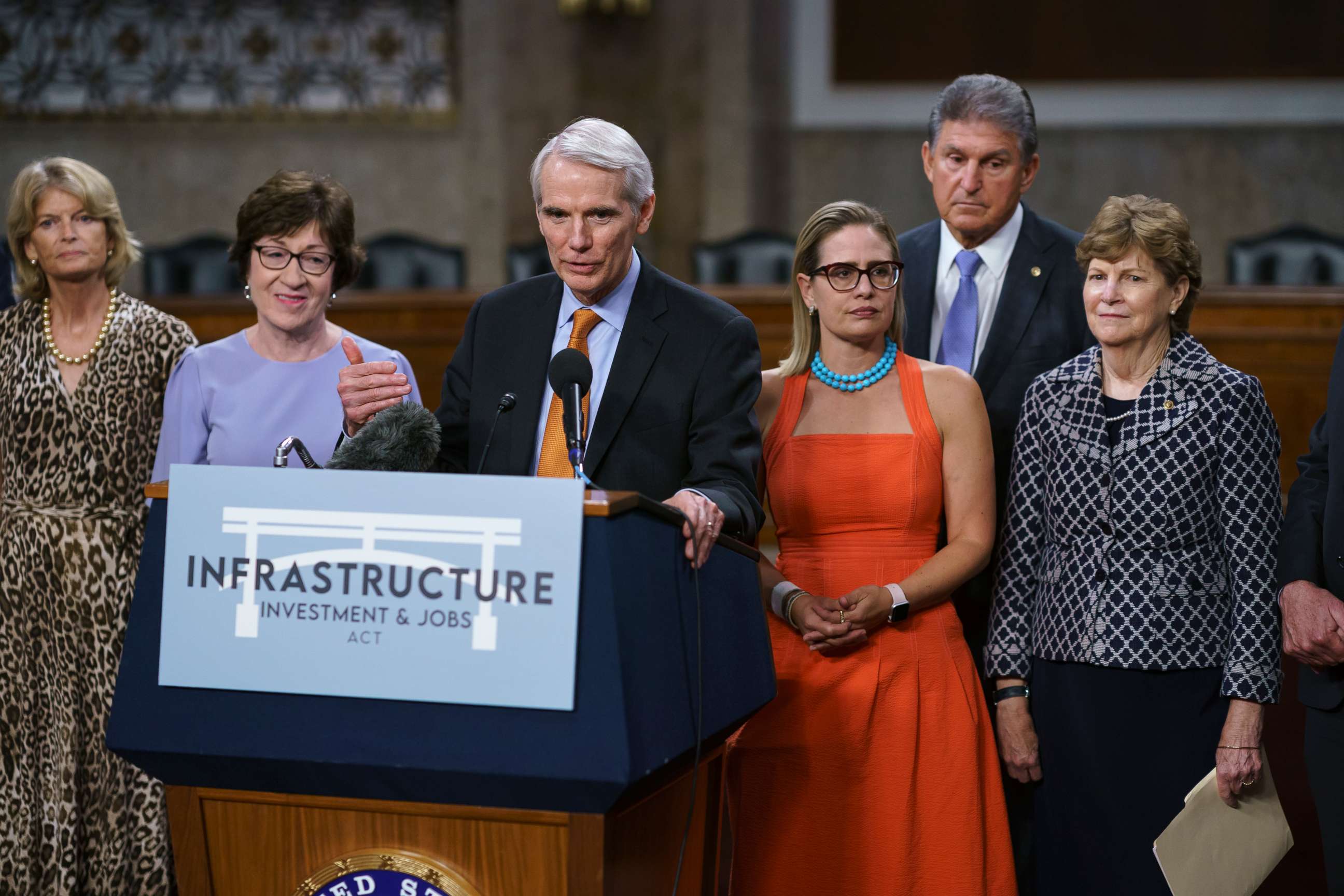 PHOTO: In this July 28, 2021, file photo the bipartisan group of Senate negotiators speak to reporters just after a vote to start work on a nearly $1 trillion bipartisan infrastructure package, at the Capitol in Washington.