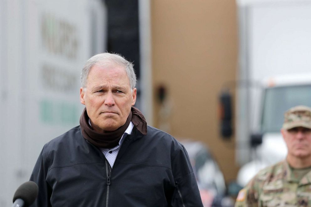 PHOTO: Gov. Jay Inslee addresses media outside Nourish Pierce County, where Washington National Guard members began packing food for delivery to 26 food banks, April 3, 2020, in Lakewood, Wash. 