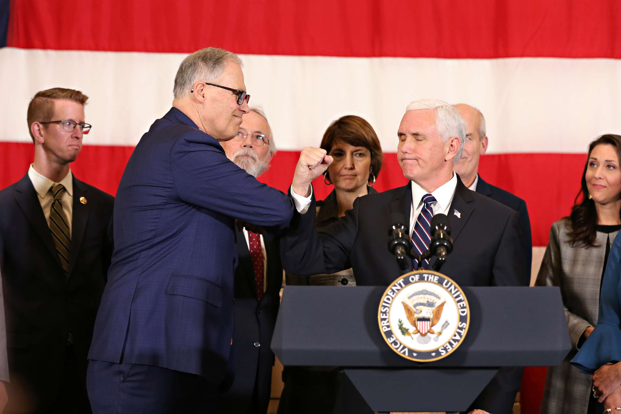 PHOTO: Washington State Governor Jay Inslee uses his elbow to greet Vice President Mike Pence greets during a press conference on March 5, 2020 at Camp Murray, adjacent to Joint Base Lewis-McChord, Washington.