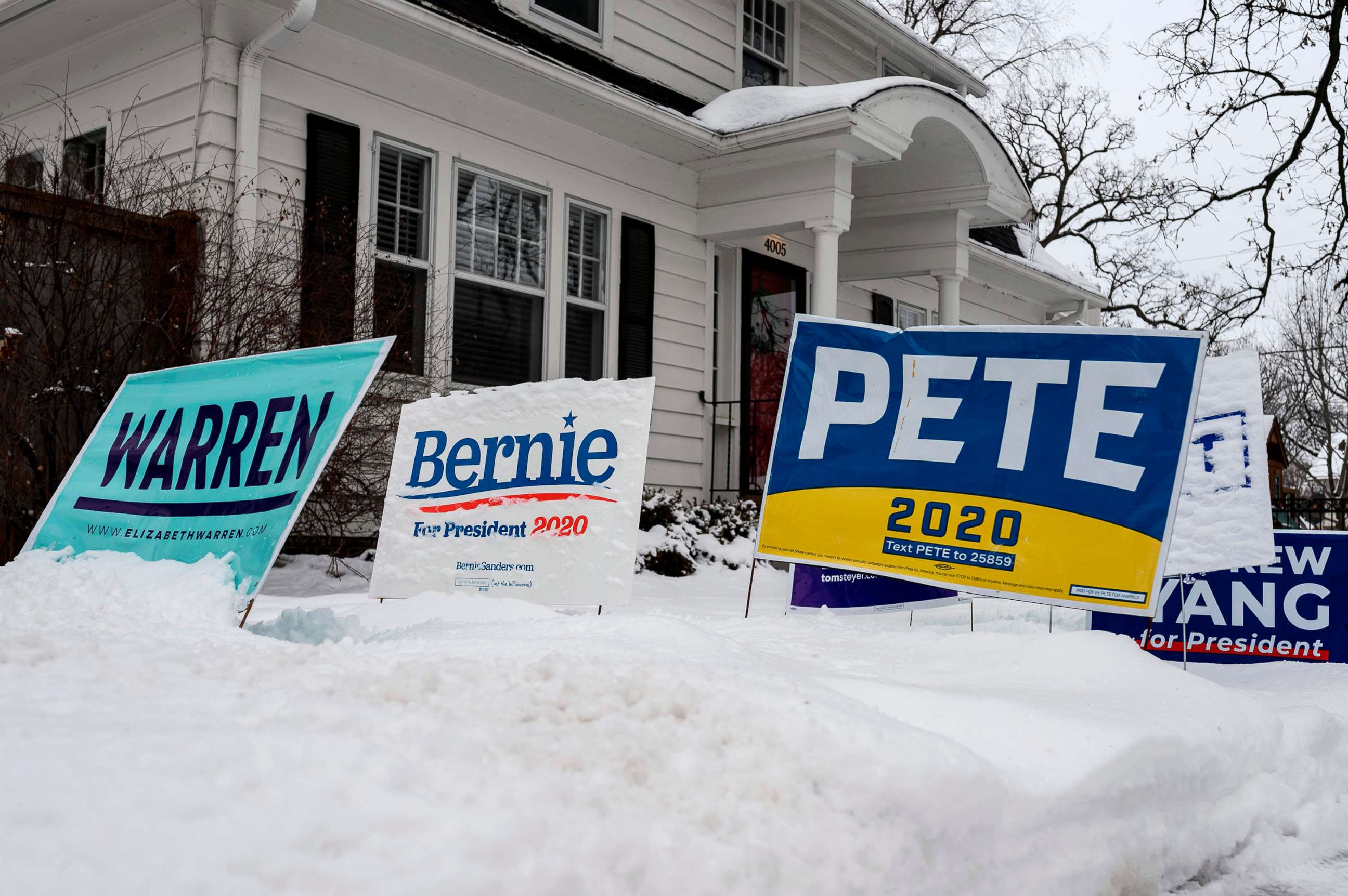 PHOTO: Signs for a number of different candidates are staked in the lawn outside of a home in Des Moines, Iowa, Jan. 25, 2020. 