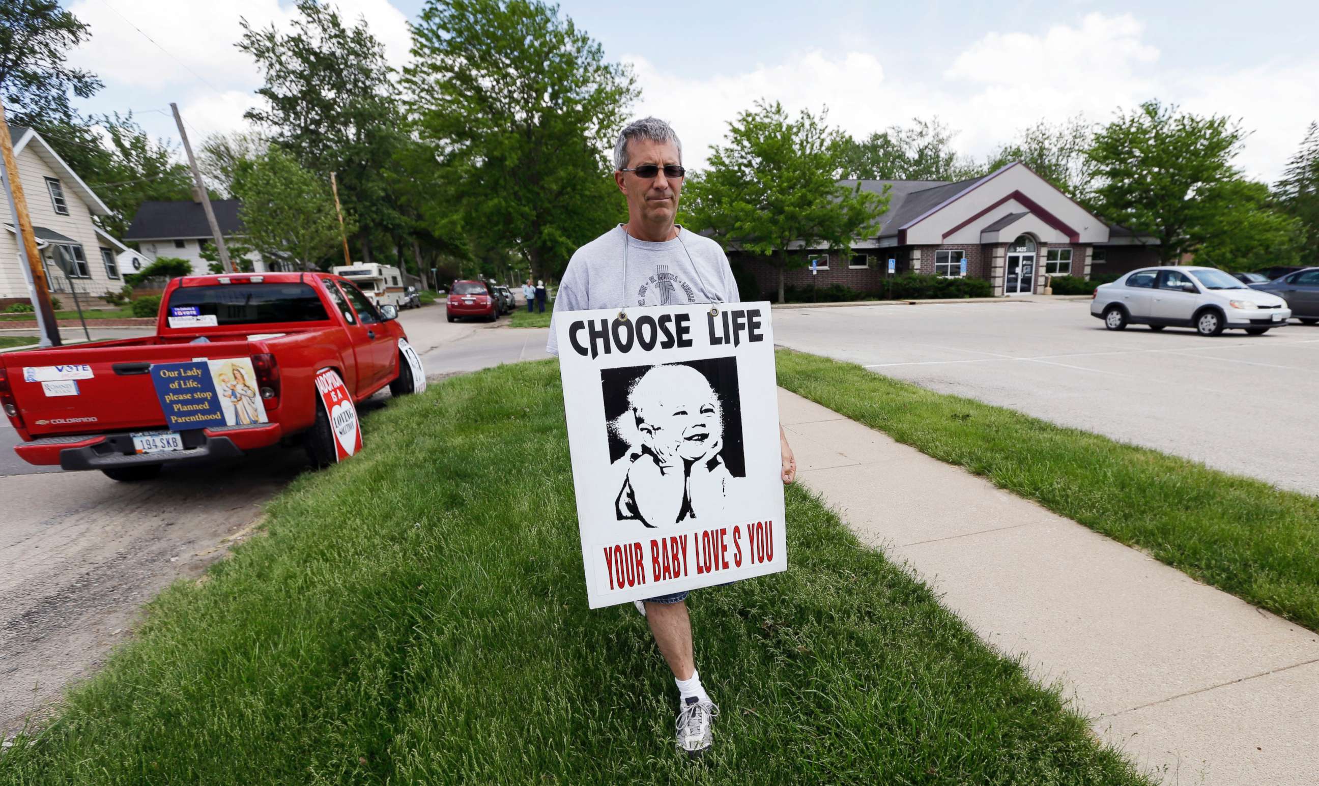 PHOTO: Coalition for Life of Iowa member Ron Digmann walks in front of the Planned Parenthood clinic, May 21, 2013, in Cedar Rapids, Iowa.
