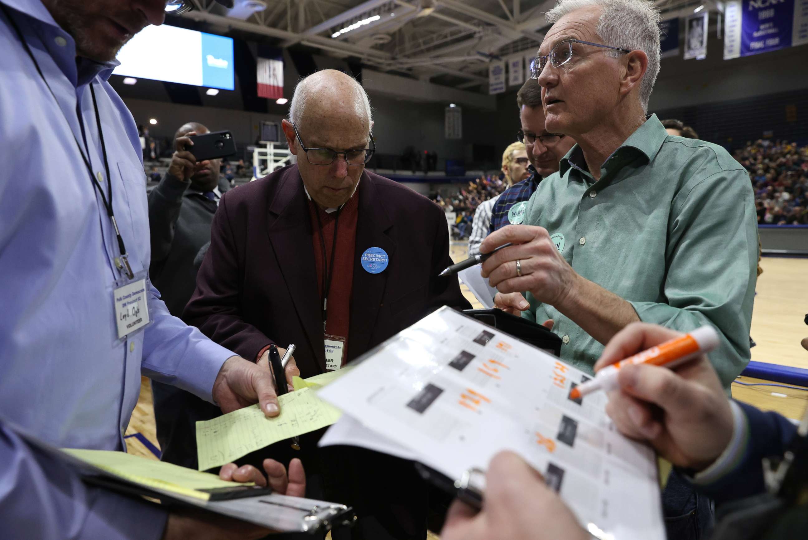 PHOTO: In this Feb. 3, 2020, file photo, a precinct secretary and other officials look over documents at a caucus in Des Moines, Iowa.