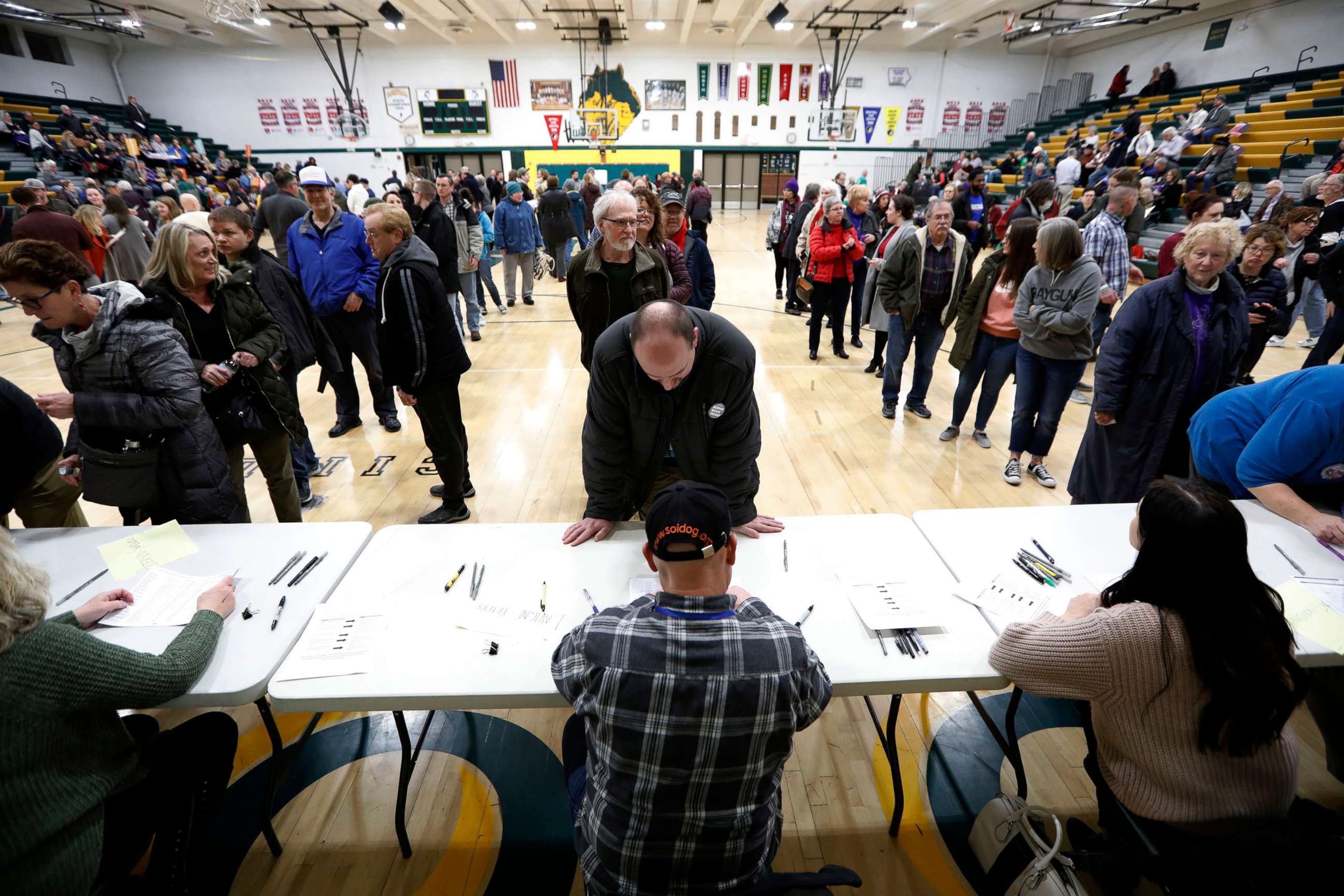 PHOTO: Local residents check-in after arriving at an Iowa Democratic caucus at Hoover High School, Feb. 3, 2020, in Des Moines, Iowa.