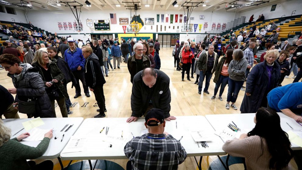 PHOTO: Local residents check-in after arriving at an Iowa Democratic caucus at Hoover High School, Feb. 3, 2020, in Des Moines, Iowa.