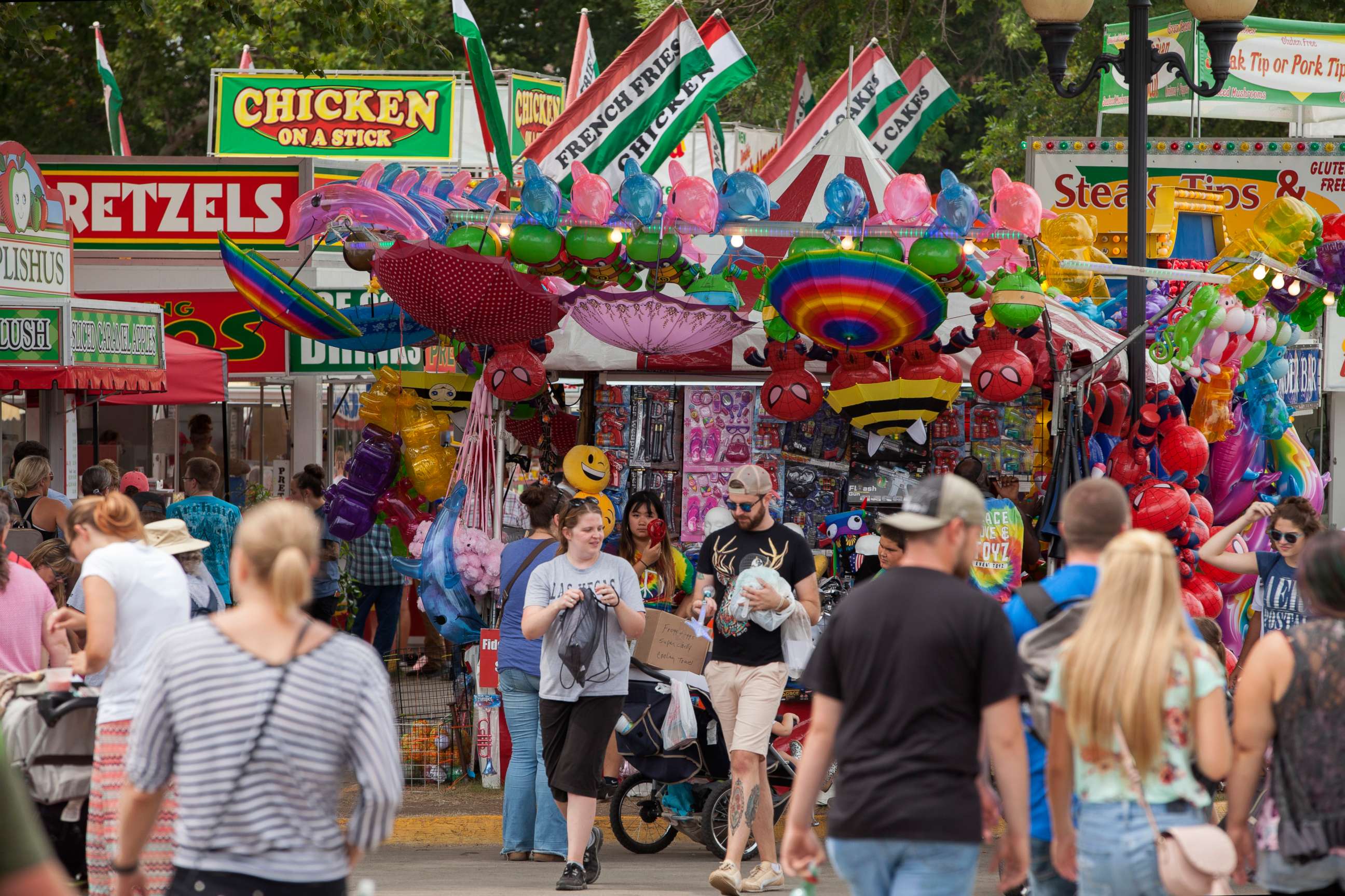 PHOTO: People walk near food kiosks at the Iowa State Fair, Aug. 19, 2018, in Des Moines, Iowa.