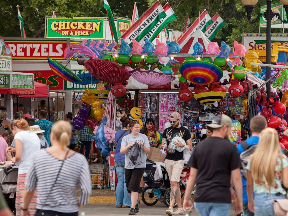 PHOTO: People walk near food kiosks at the Iowa State Fair, Aug. 19, 2018, in Des Moines, Iowa.