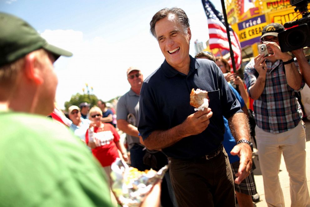 PHOTO: Republican presidential candidate Mitt Romney eats a pork chop on a stick while speaking to voters at the Iowa State Fair on August 11, 2011 in Des Moines, Iowa.