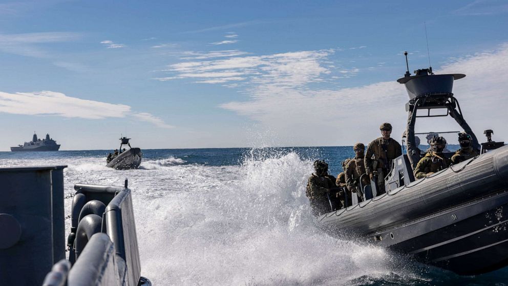 PHOTO: A U.S. Marine with the 26th Marine Expeditionary Unit (MEU), prepare to board a ship during a visit, board, search, and seizure training mission in support of Amphibious Squadron/MEU Integrated Training (PMINT), in the Atlantic Ocean Jan. 27, 2023.