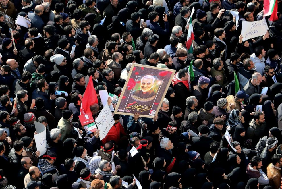 PHOTO: Iranian mourners lift a picture of slain military commander Qassem Soleimani during a funeral procession in Tehran, Jan. 6, 2020, for him as well as Iraqi paramilitary chief Abu Mahdi al-Muhandis and other victims of a U.S. drone strike.