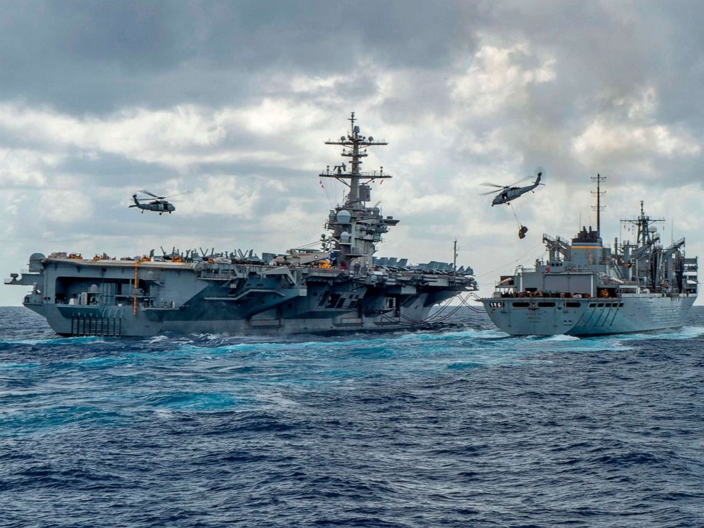 PHOTO: The USS Abraham Lincoln and USNS Arctic are pictured as helicopters transfer stores between the ships, May 8, 2019. The US is deploying ships and bombers to the Gulf, to put pressure on Iran. 