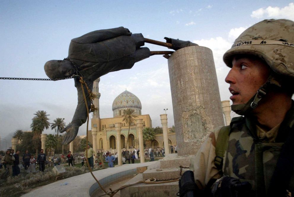 PHOTO: U.S. Marine Corp assault-man Kirk Dalrymple watches as a statue of Iraq's President Saddam Hussein falls in central Baghdad's Firdaus Square, Apr. 9, 2003.