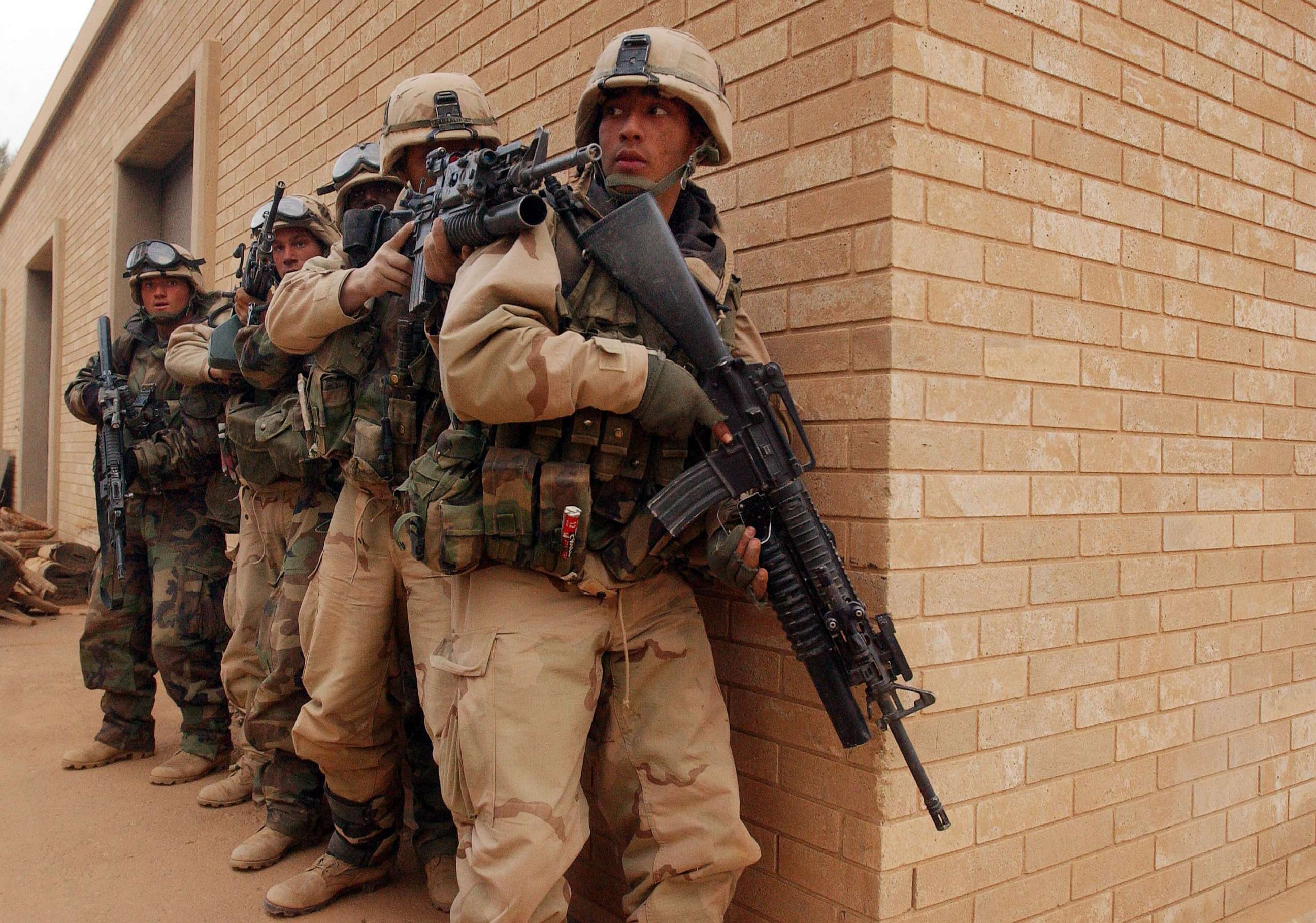 PHOTO: U.S. Army 3rd Division 3-7 soldiers move to secure the VIP terminal of Baghdad International Airport during a dawn advance Apr. 4, 2003.