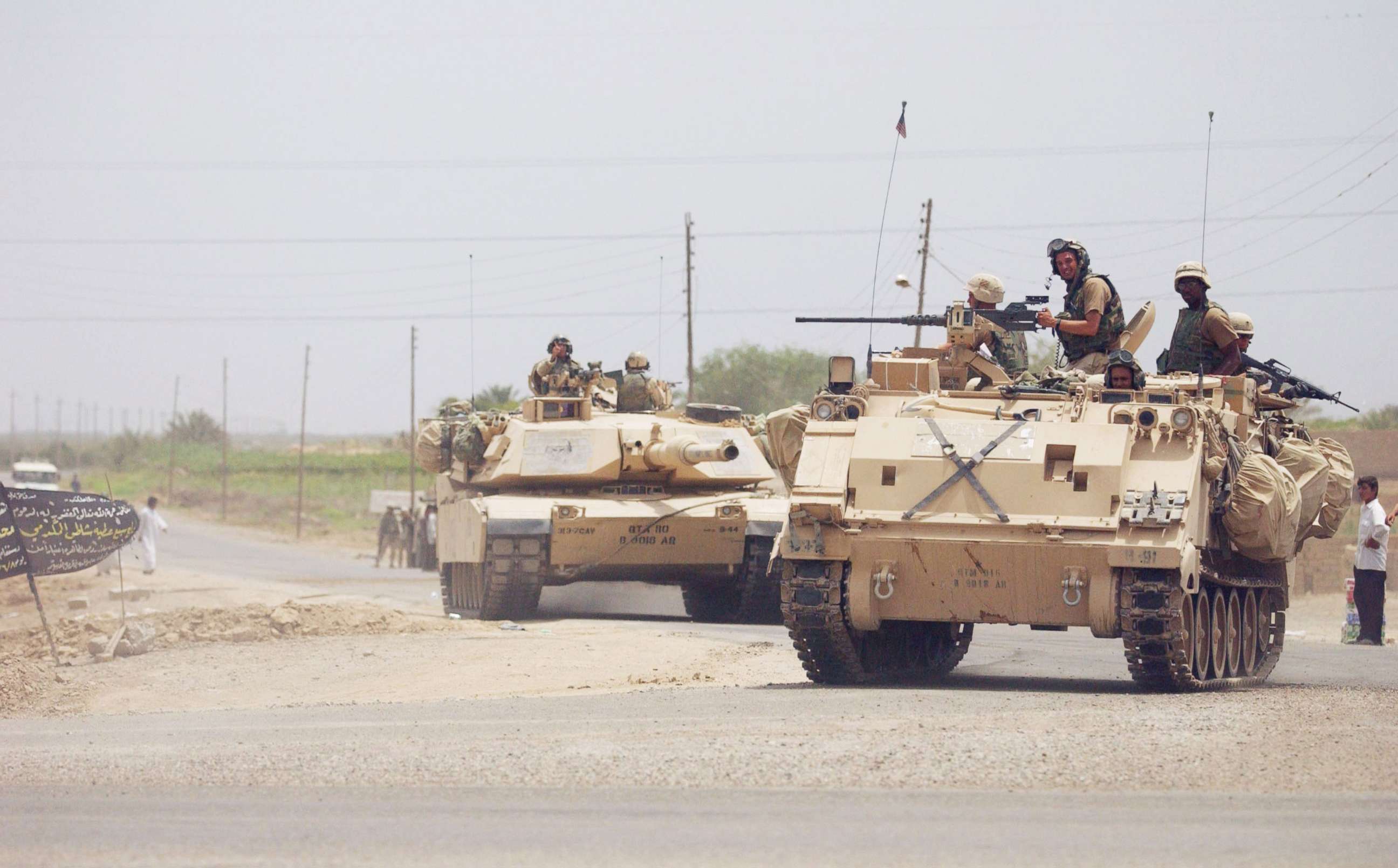 PHOTO: U.S. troops patrol the streets following a military operation in which coalition forces detained over 400 suspects and confiscated numerous weapons and ammunition on June 13, 2003, in the outskirst of Duluiyah, 30 miles north of Baghdad, Iraq.