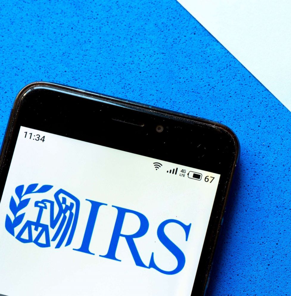 Image: In this illustration, the IRS logo is displayed on a smartphone.