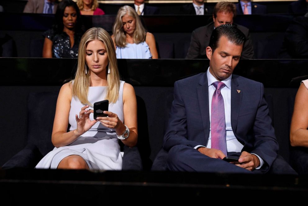 PHOTO: Ivanka Trump and Donald Trump Jr. check on their phones during the second day session of the Republican National Convention in Cleveland, Tuesday, July 19, 2016.
