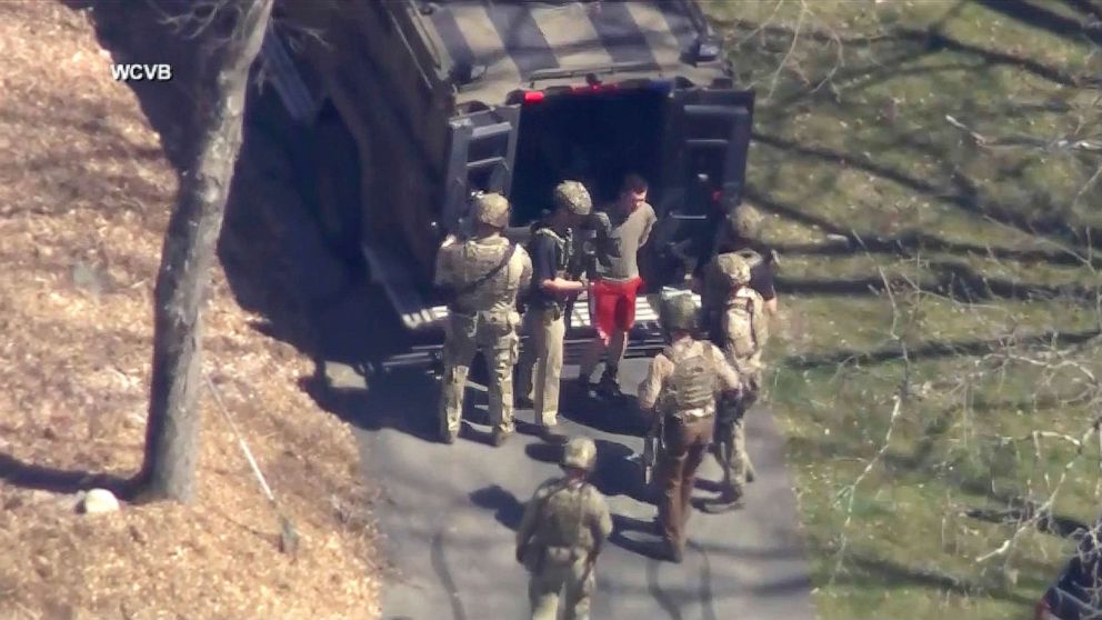 PHOTO: This image made from video provided by WCVB-TV, shows Jack Teixeira, in T-shirt and shorts, being taken into custody by armed tactical agents on April 13, 2023, in Dighton, Mass.