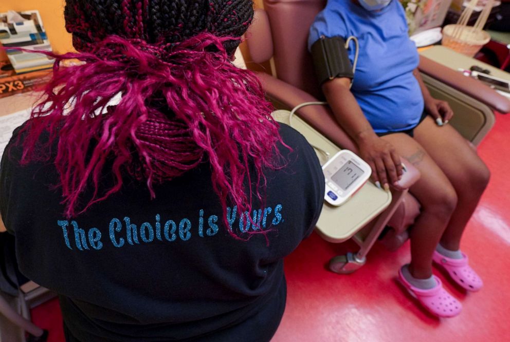 PHOTO: A technician wears a shirt supporting a woman's right to abortion while checking a patient's blood pressure at Jackson Women's Health Organization - the only remaining abortion clinic in the state - on June 29, 2021 in Jackson, Miss.