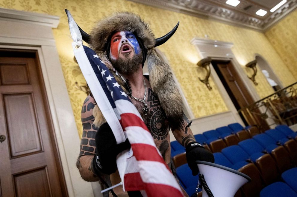 PHOTO: FILE - Jacob Chansley, also known as the "QAnon Shaman," screams "Freedom" inside the U.S. Senate chamber after the U.S. Capitol was breached by a mob during a joint session of Congress, Jan. 6, 2021 in Washington, DC.