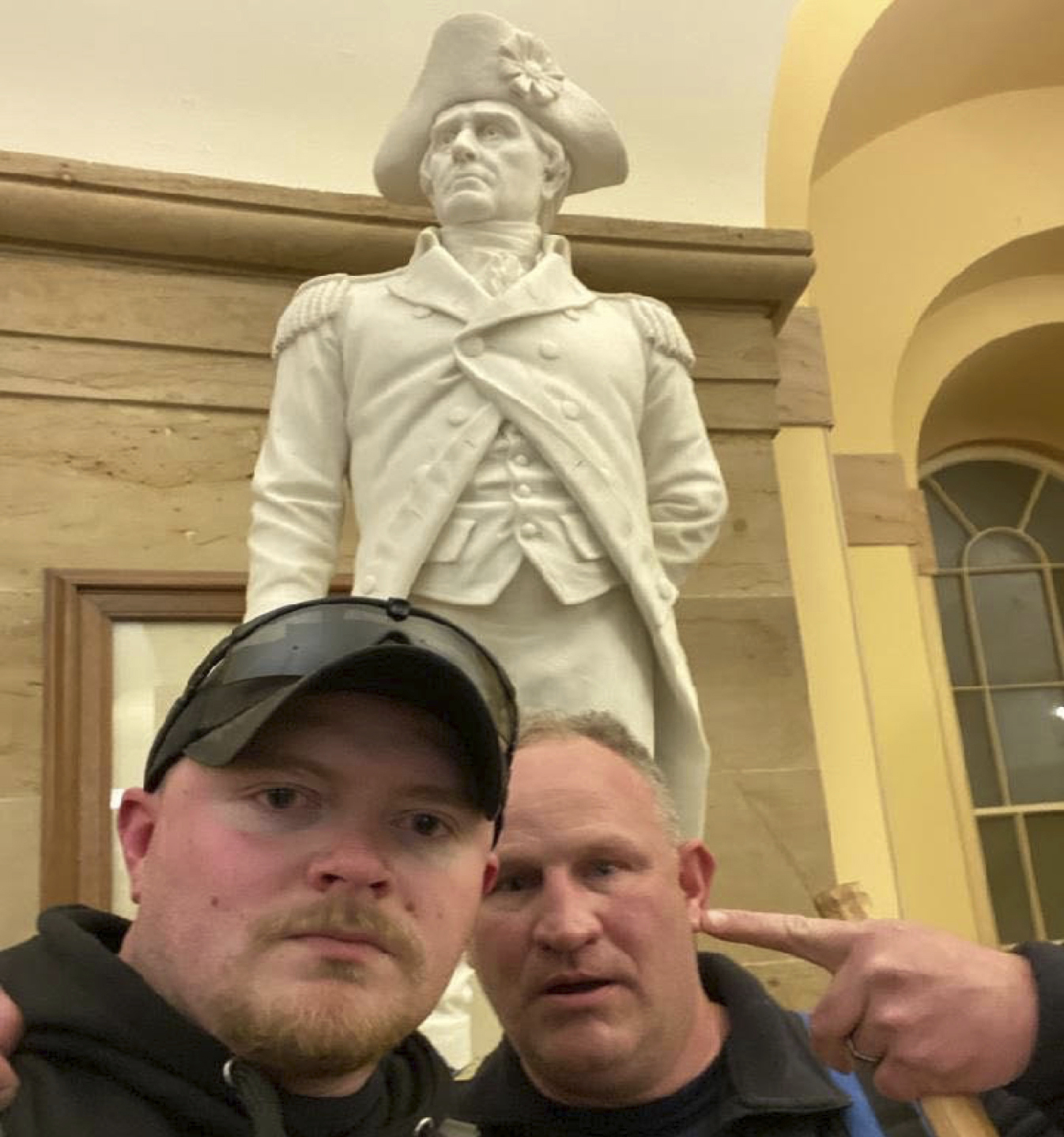 PHOTO: This Jan. 6, 2021 photo from the United States Capitol Police in a complaint and arrest warrant shows Rocky Mount Police Department Sgt. Thomas "T.J." Robertson and officer Jacob Fracker in the Capitol in front of a statue of John Stark.