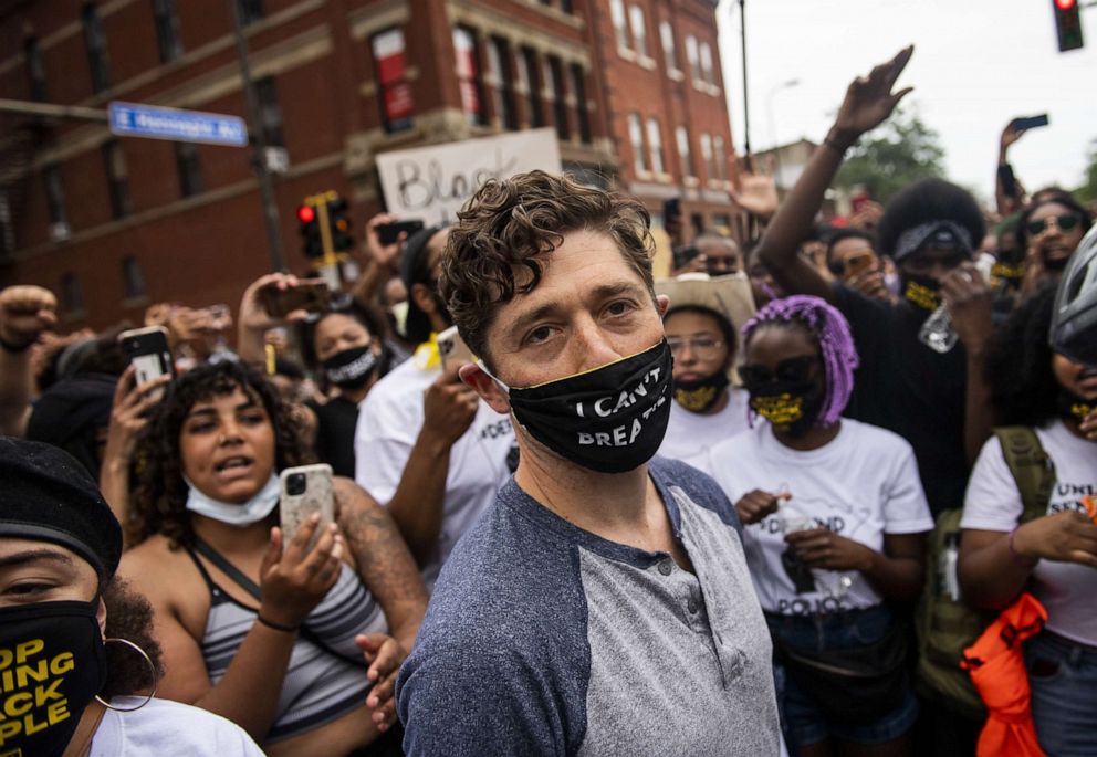 PHOTO: Minneapolis Mayor Jacob Frey leaves after coming out of his home to speak during a demonstration calling for the Minneapolis Police Department to be defunded on June 6, 2020, in Minneapolis.