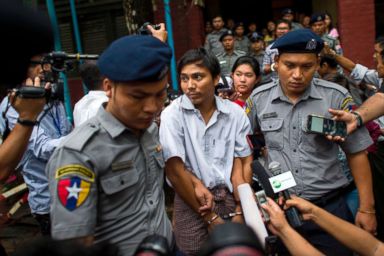 PHOTO: Police escort detained Myanmar journalist Kyaw Soe Oo after appearing before a court trial in Yangon, Myanmar, Aug. 20, 2018.