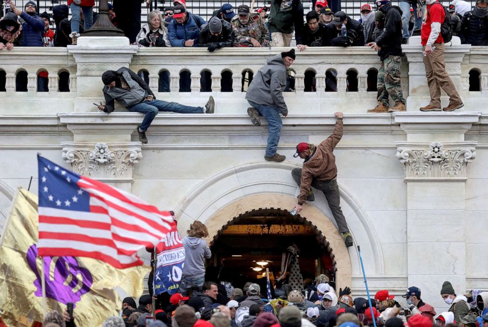 PHOTO: A mob of supporters of then-President Donald Trump fight with members of law enforcement at a door they broke open as they storm the U.S. Capitol Building in Washington, D.C., Jan. 6, 2021.