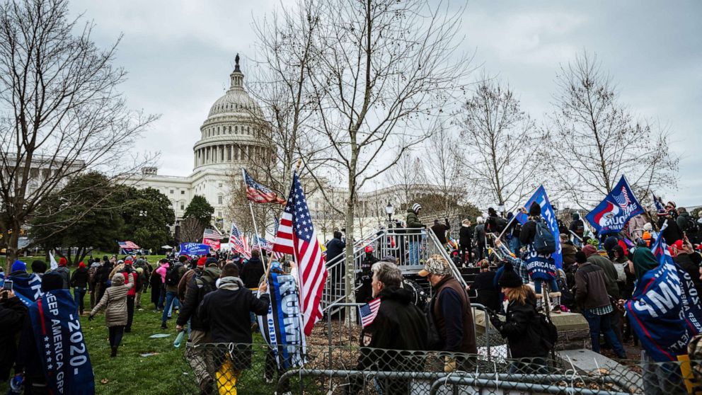PHOTO: A large group of pro-Trump protesters push past police and barriers to enter the Capitol on January 6, 2021 in Washington, DC.