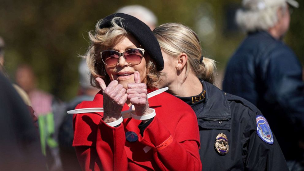 PHOTO: Actor and activist Jane Fonda gives a thumbs up in handcuffs as she is detained for blocking the street in front of the Library of Congress during the "Fire Drill Fridays" protest in Washington, Oct. 18, 2019.