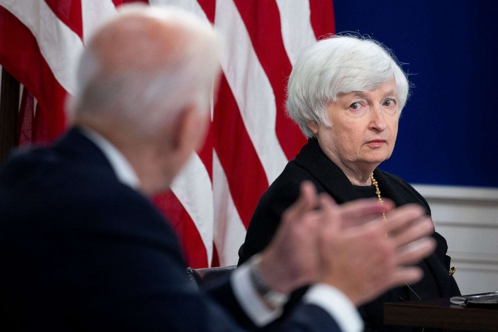 PHOTO: Treasury Secretary Janet Yellen watches as President Joe Biden speaks during a meeting with members of his administration and business leaders in the Eisenhower Executive Office Building on the White House complex in Washington, Oct. 6, 2021.