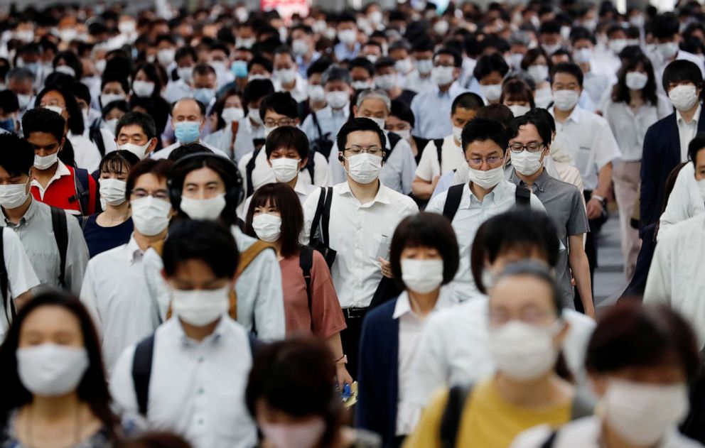 PHOTO: People wearing protective masks amid the coronavirus disease (COVID-19) outbreak, make their way during rush hour at a railway station in Tokyo, Japan, July 3, 2020.