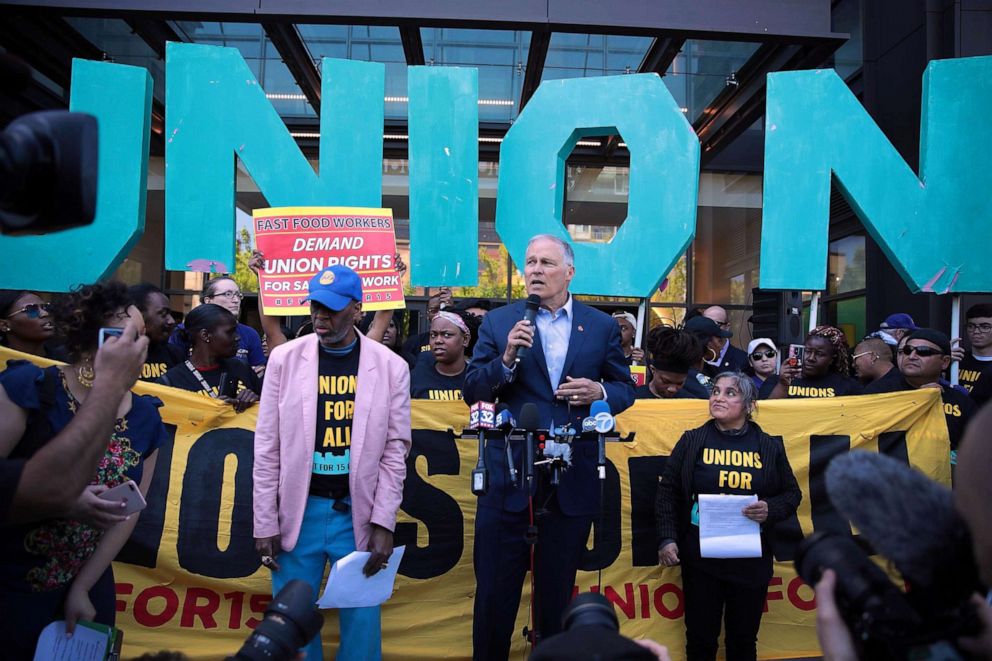 PHOTO: Democratic presidential candidate and Washington governor Jay Inslee joins demonstrators at a rally in front of McDonald's corporate headquarters to demand $15-per-hour wages for fast food workers, May 23, 2019, in Chicago.