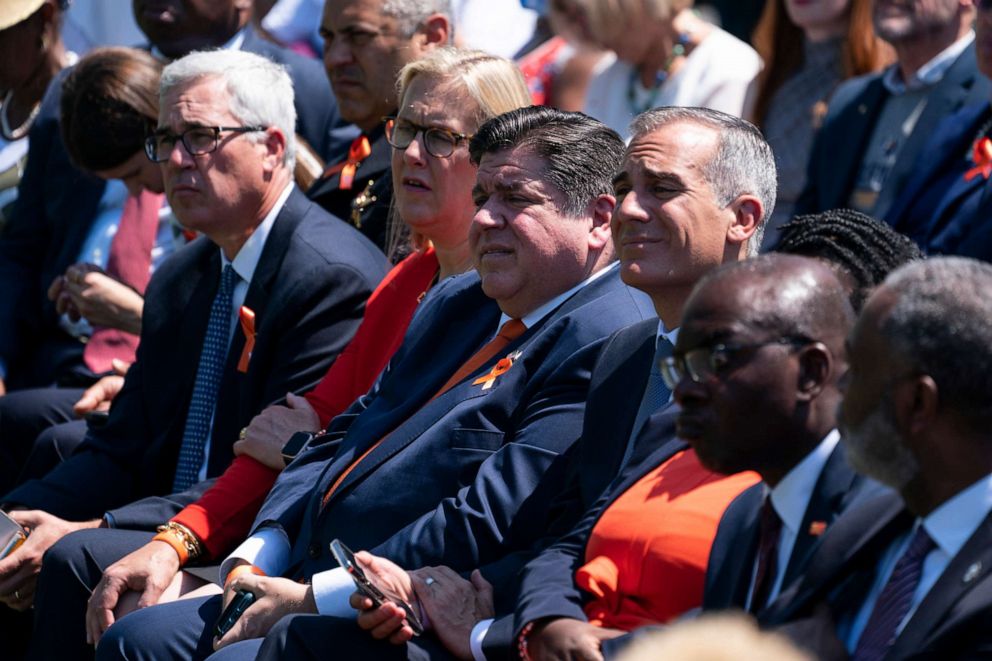 PHOTO: Gov. J.B. Pritzker listens as President Joe Biden speaks during an event to celebrate the passage of the "Bipartisan Safer Communities Act," a law meant to reduce gun violence, on the South Lawn of the White House, July 11, 2022, in Washington.