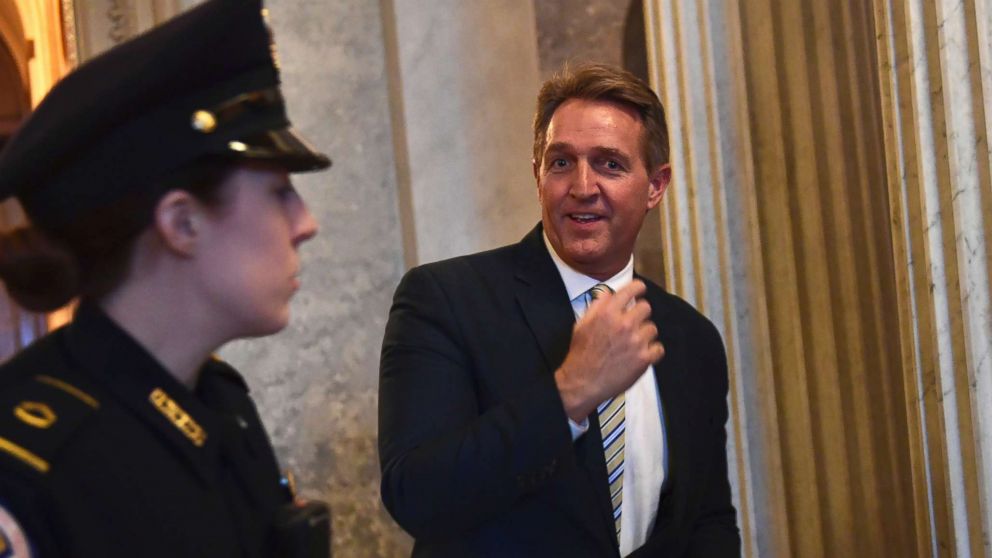 Sen. Jeff Flake walks on Capitol Hill in Washington, Dec. 5, 2017, following the weekly Republican policy luncheon.