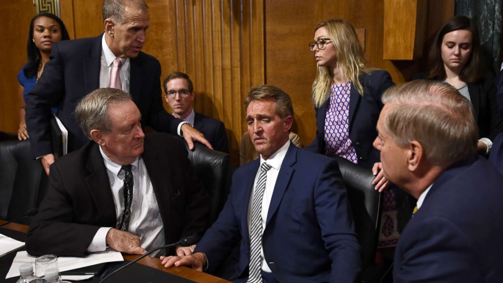 Senate Judiciary Committee member Sen. Jeff Flake speaks with committee colleagues during a hearing in Washington on Sept. 28, 2018, after requested a delay for a floor vote to allow for an FBI investigation.