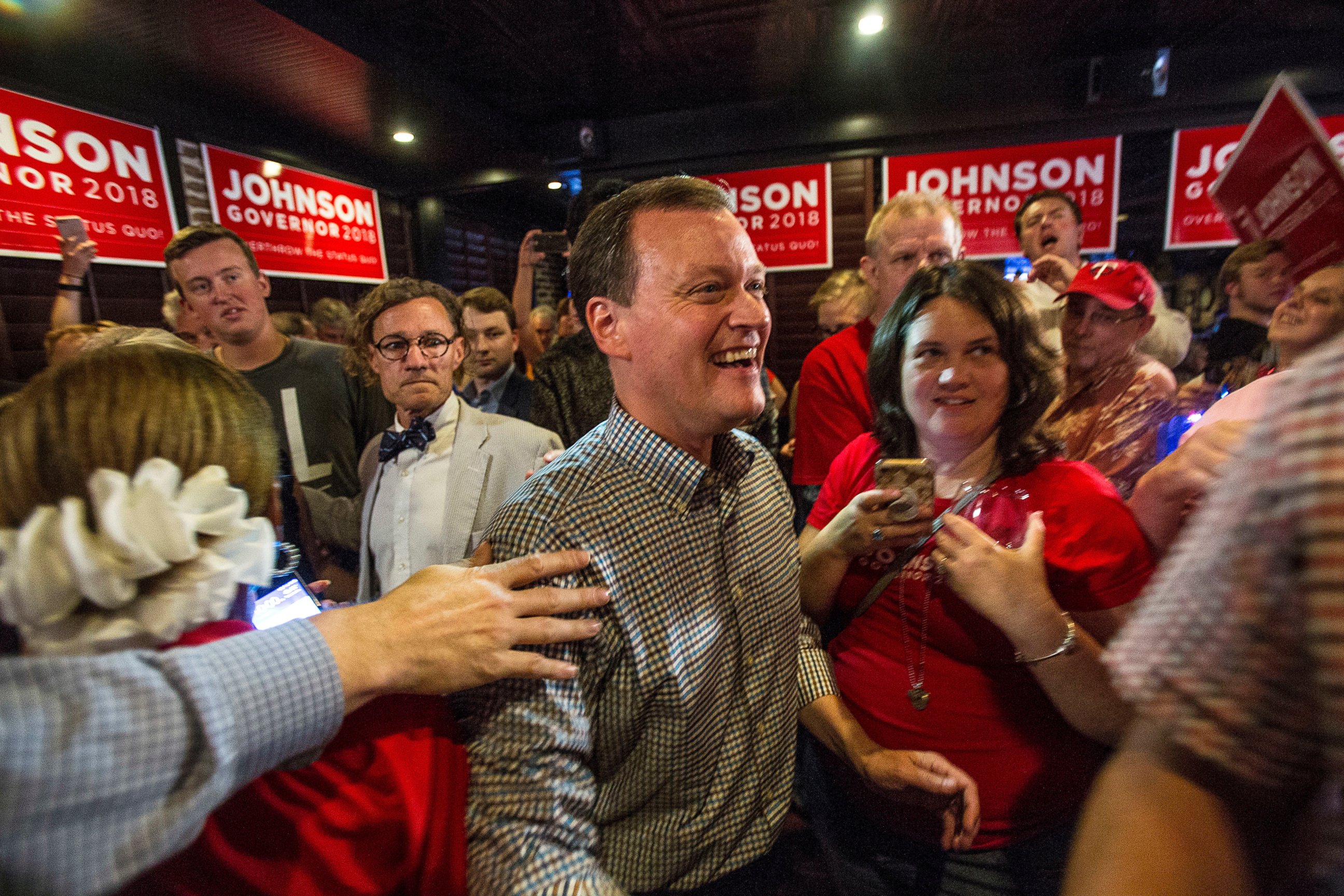 Minnesota gubernatorial candidate Jeff Johnson, center, is greeted by his supporters after returning to the watch party, Tuesday, Aug. 14, 2018, in Plymouth, Minn.