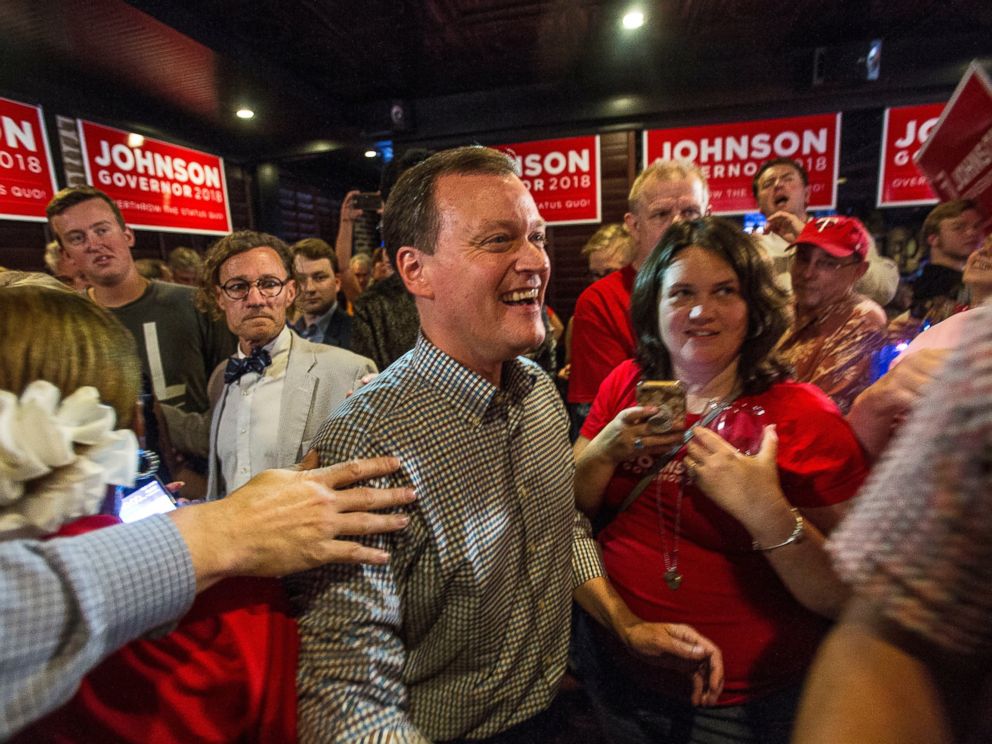 Minnesota gubernatorial candidate Jeff Johnson, center, is greeted by his supporters after returning to the watch party, Tuesday, Aug. 14, 2018, in Plymouth, Minn.