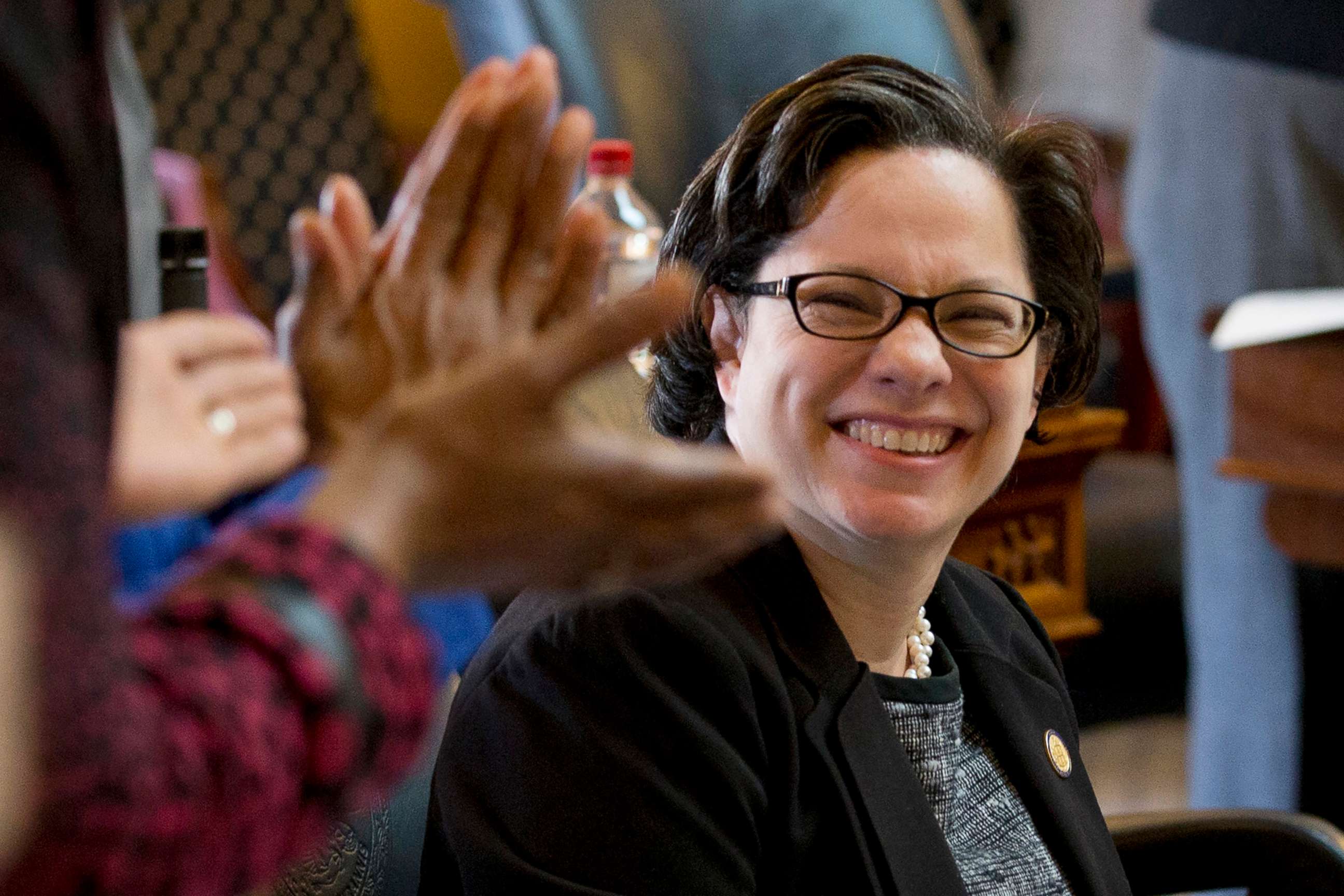 PHOTO: State Sen. Jennifer McClellan smiles as she is applauded by members of the Virginia House of Delegates during a warm send-off from the chambers at the Capitol in Richmond, Va.