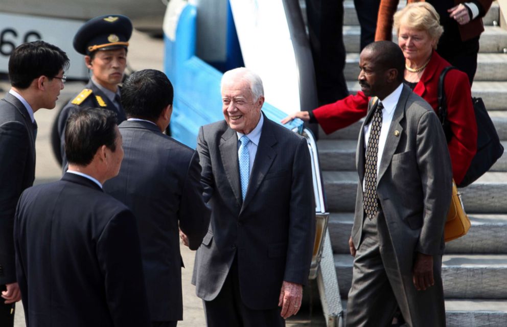 PHOTO: Former U.S. President Jimmy Carter, accompanied by his delegation members, is greeted upon arrival in Pyongyang, North Korea, April 26, 2011.