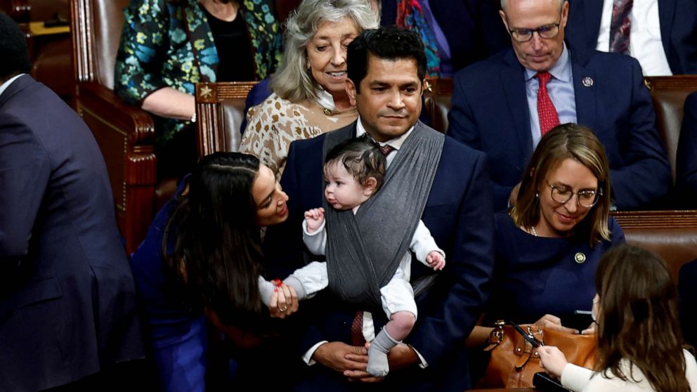 PHOTO: FILE - U.S. Rep. Alexandria Ocasio-Cortez talks to the infant child of Rep. Jimmy Gomez inside the House Chamber during votes for the next Speaker of the House on the first day of the 118th Congress at the U.S. Capitol in Washington, Jan. 3, 2023.