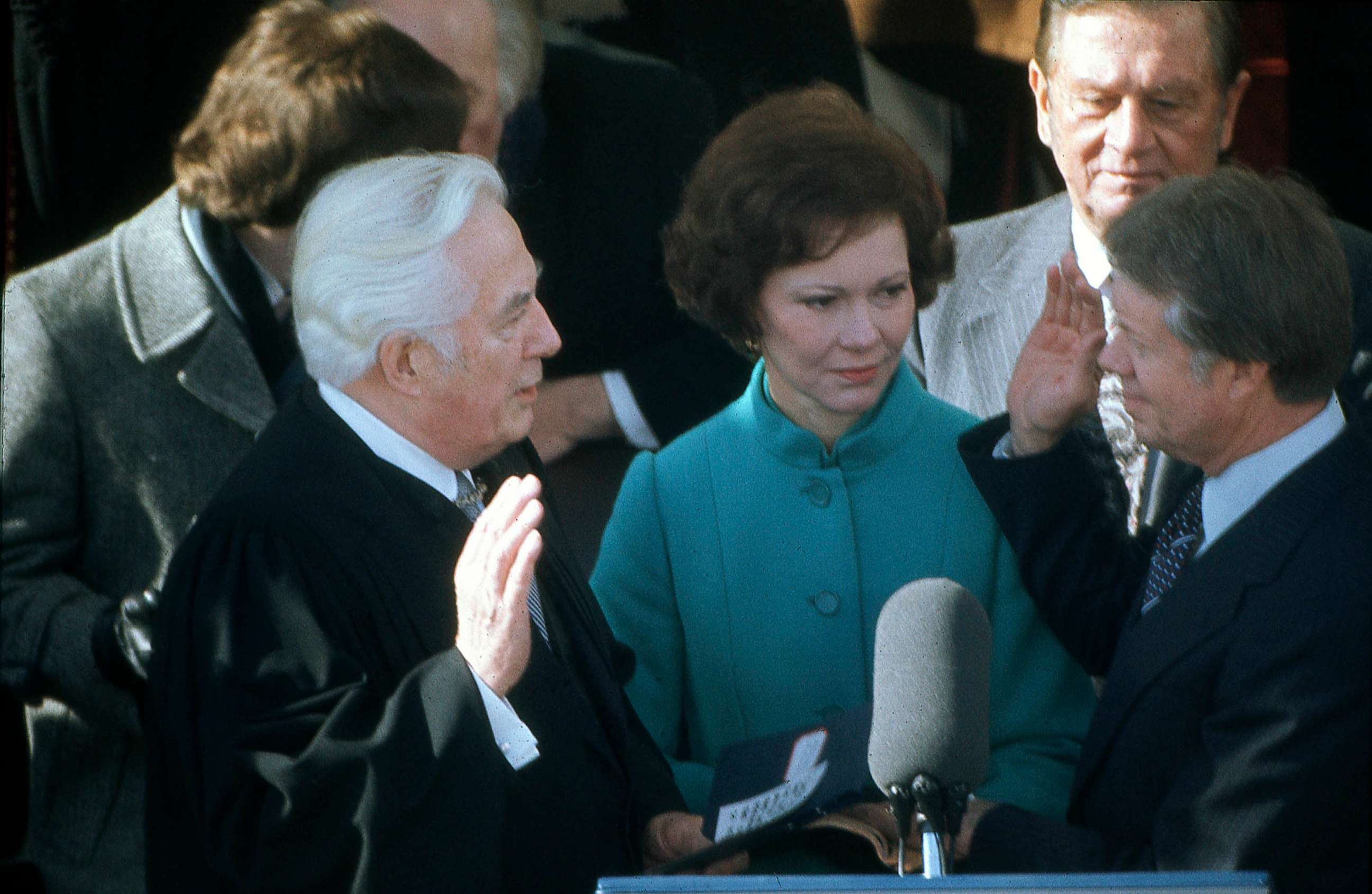 PHOTO: FILE - President Jimmy Carter with wife Rosalyn Carter, takes the oath of office from Chief Justice of the Supreme Court Warren Burger on stage in front of the White House, Jan. 1977.