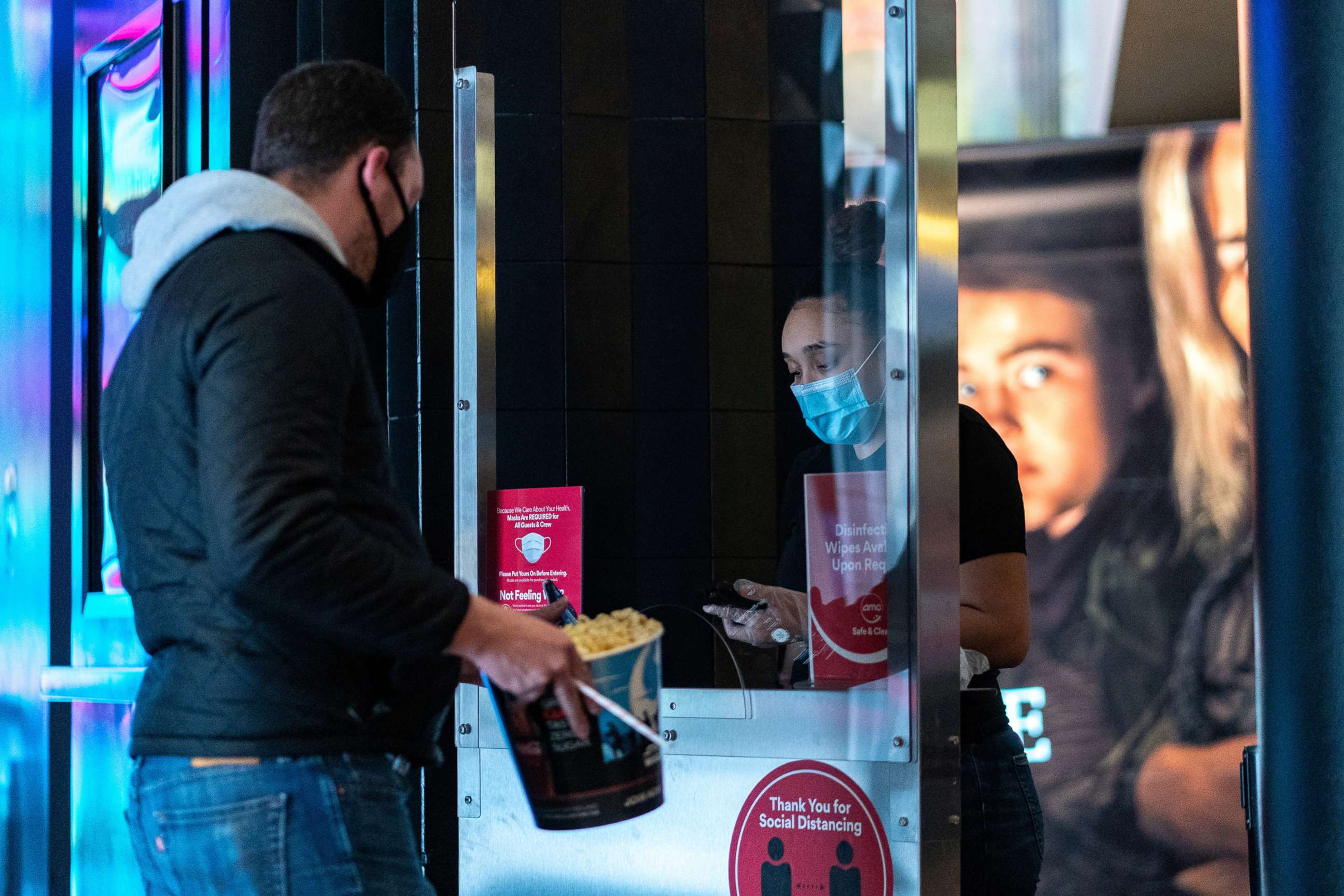 PHOTO: A staff wearing a protective mask works at the AMC movie theatre in Lincoln Square, amid the COVID-19 pandemic, in New York, March 6, 2021.