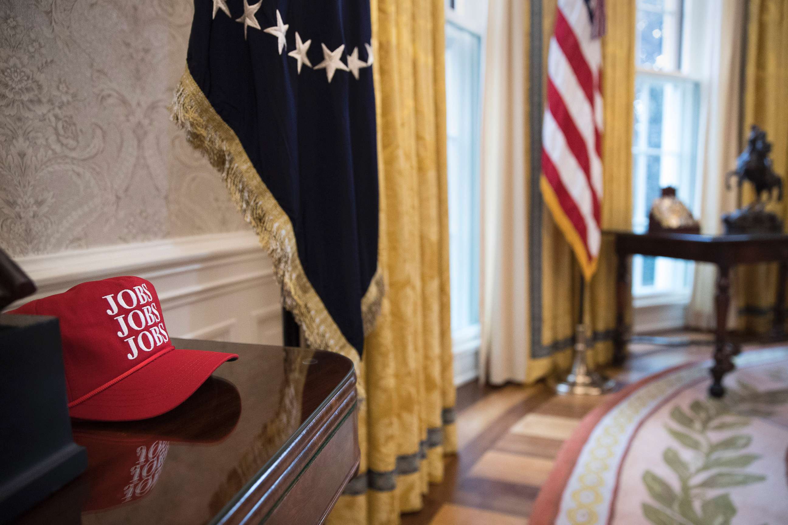 PHOTO: A red hat with "Jobs, Jobs, Jobs" printed on it rests on a table in the Oval Office, Jan. 31, 2018.