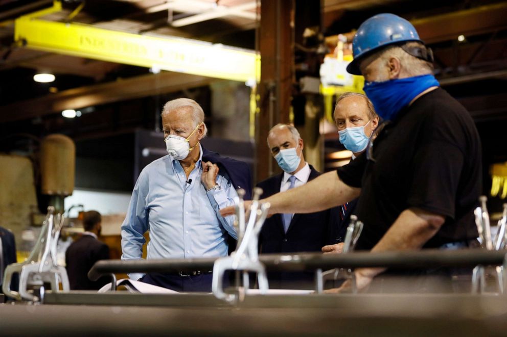 PHOTO: Democratic presidential candidate, former Vice President Joe Biden, Sen. Bob Casey and McGregor Industries owner Bob McGregor listen to First Class Fitter Dave Callis during a tour of the metal fabricating facility, July 9, 2020, in Dunmore, Pa.