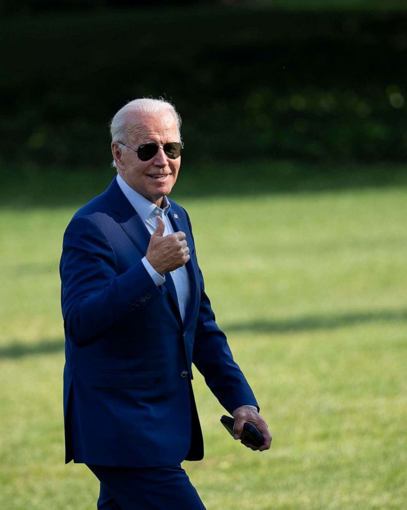 PHOTO: U.S. President Joe Biden gestures toward reporters as he departs Marine One and walks to the Oval Office on the South Lawn of the White House, July 20, 2022, in Washington.