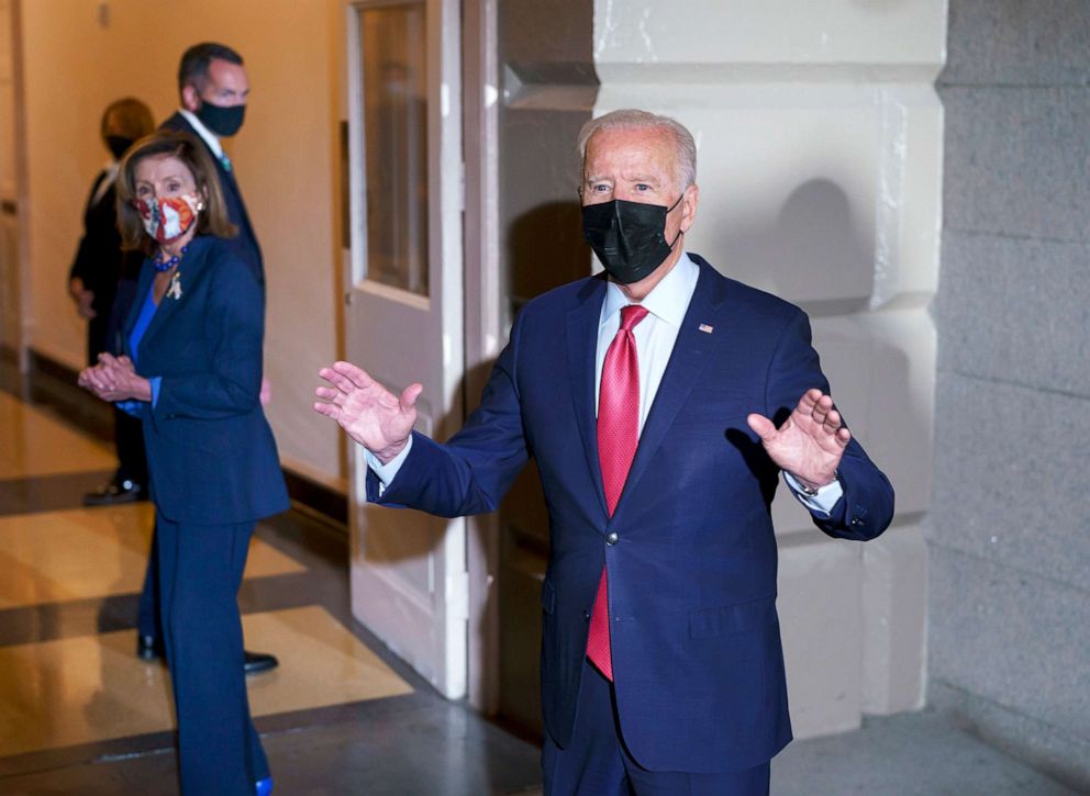 PHOTO: President Joe Biden responds to questions shouted by reporters as he and Speaker of the House Nancy Pelosi walk in a basement hallway of the Capitol in Washington, Oct. 1, 2021.