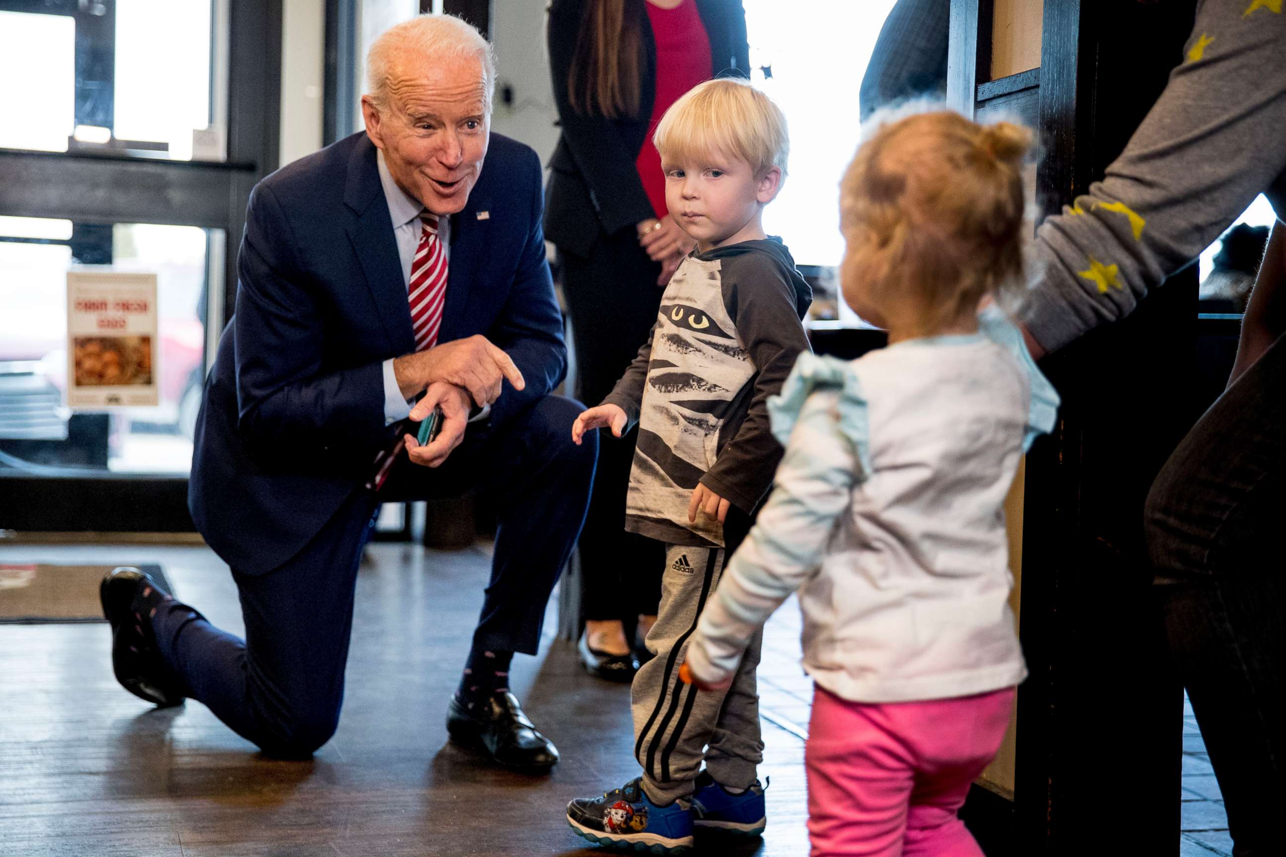 PHOTO: Democratic presidential candidate former Vice President Joe Biden speaks with Jack Maiers, 4, and his sister Olive, 2, right, of Bettendorf, Iowa, as he arrives for lunch at Ross' Restaurant, Jan. 6, 2020, in Bettendorf, Iowa.