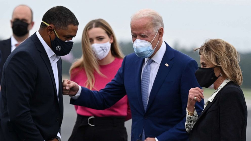 PHOTO: Democratic Presidential Candidate Joe Biden is greeted by Congressman Cedric Richmond as he arrives with his granddaughter Finnegan Biden and his sister Valerie in Columbus, Georgia, Oct. 27, 2020.