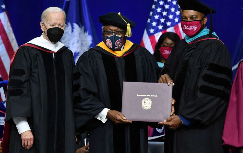 PHOTO: In this Dec. 17, 2021, file photo, Representative Jim Clyburn, with President Joe Biden, receives his history diploma from Interim South Carolina State University President Alexander Conyers during a commencement ceremony in Orangeburg, S.C.