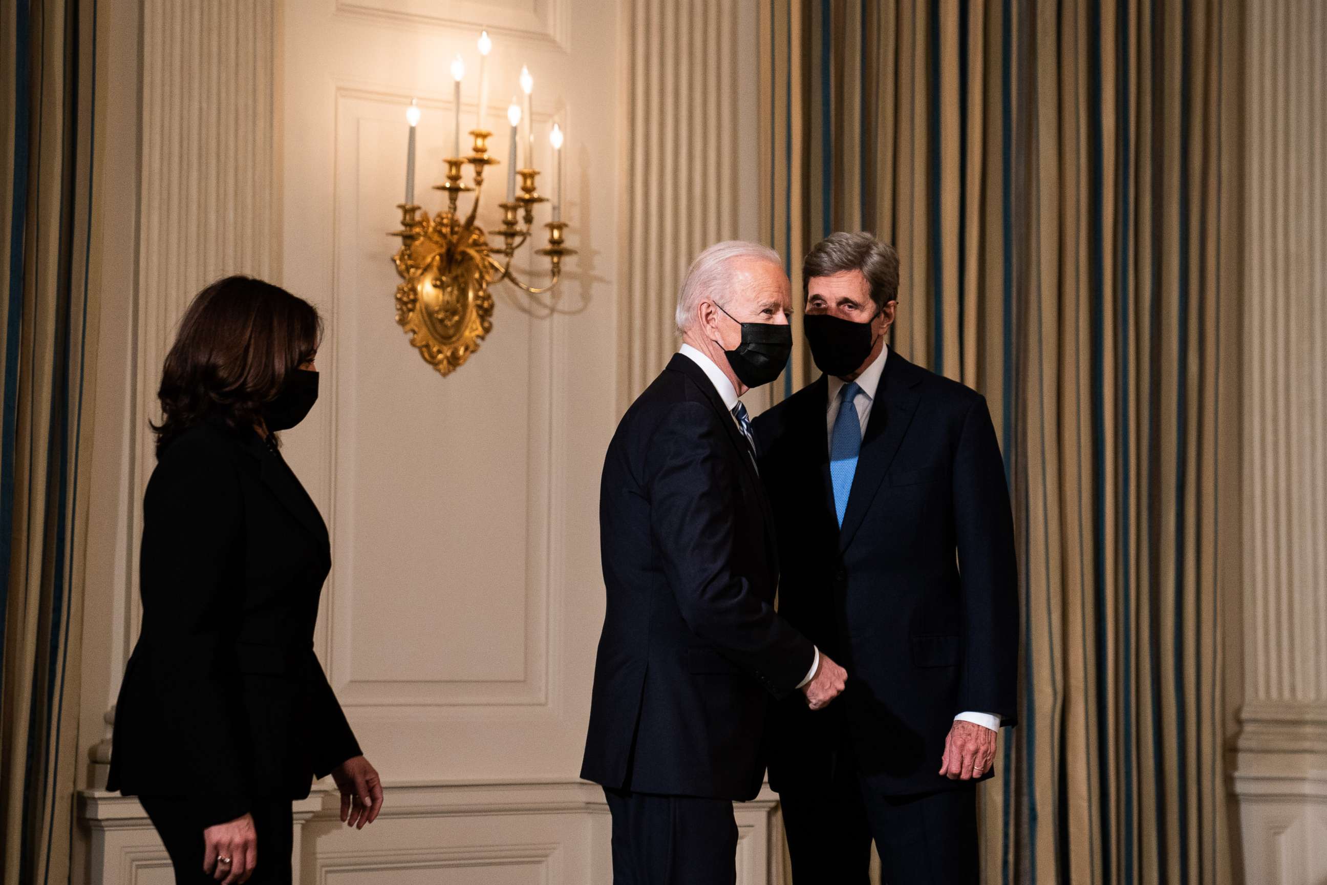 PHOTO: President Joe Biden greets Special Presidential Envoy for Climate John Kerry as he arrives to speak about climate change issues in the State Dining Room of the White House on Jan. 27, 2021, in Washington, D.C.