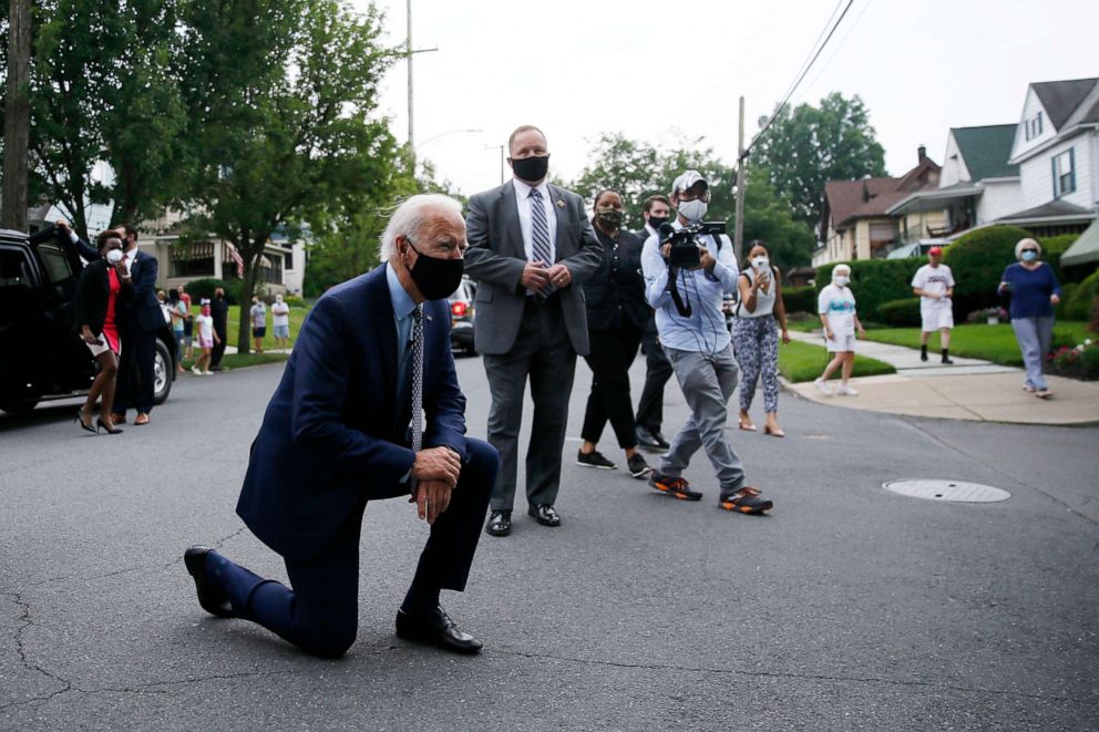 PHOTO: Democratic presidential candidate, former Vice President Joe Biden kneels to talk with a child during a visit to Biden's childhood home in Scranton, Pa., on Thursday, July 9, 2020.